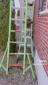 little giant sumostance ladder against a brick house with an electrical service in the background.